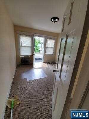 24 Washington Place, Unit 2 Teaneck, NJ 07666 - Photo 11 of 12 a view of an empty room with a fireplace