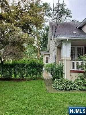 24 Washington Place, Unit 2 Teaneck, NJ 07666 - Photo 4 of 12 a view of a brick house with a yard and plants