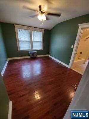 24 Washington Place, Unit 2 Teaneck, NJ 07666 - Photo 9 of 12 an empty room with wooden floor and windows