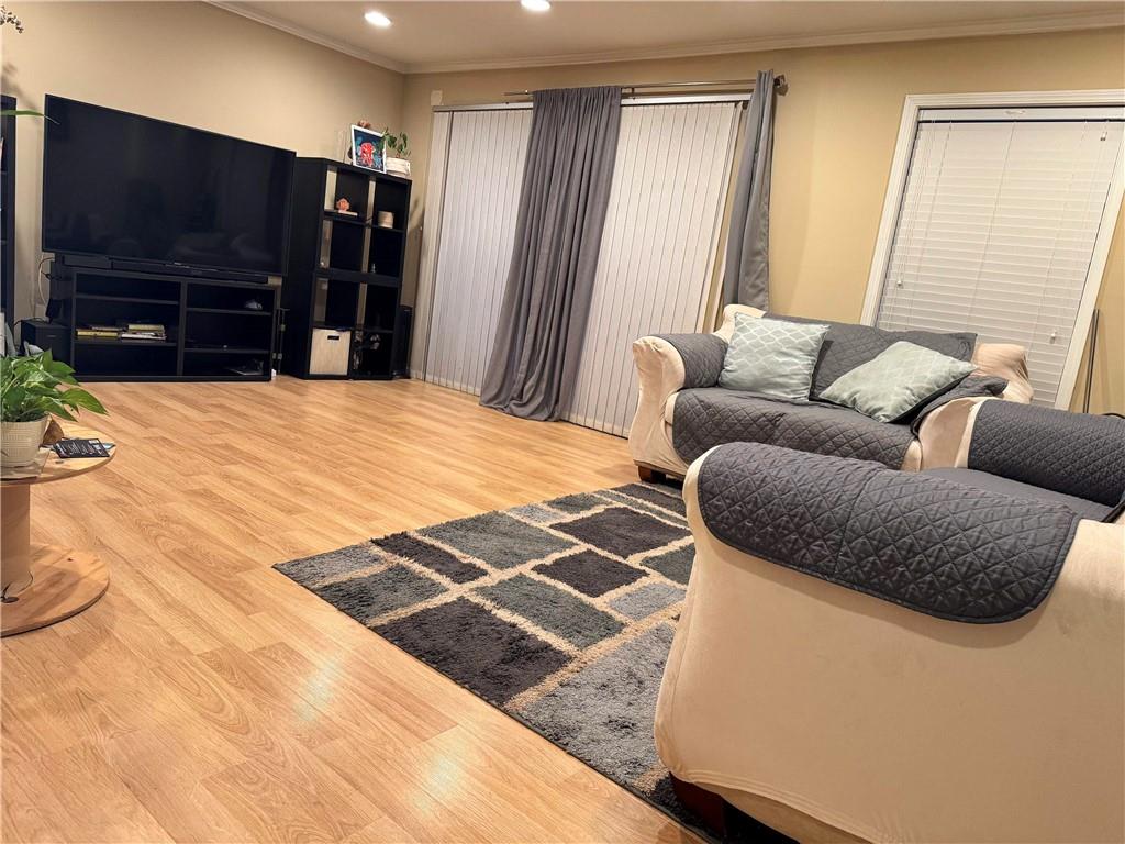 6851 Roswell Road, Unit O24 Sandy Springs, GA 30328 - Photo 2 of 10 a living room with a couch and a flat screen tv