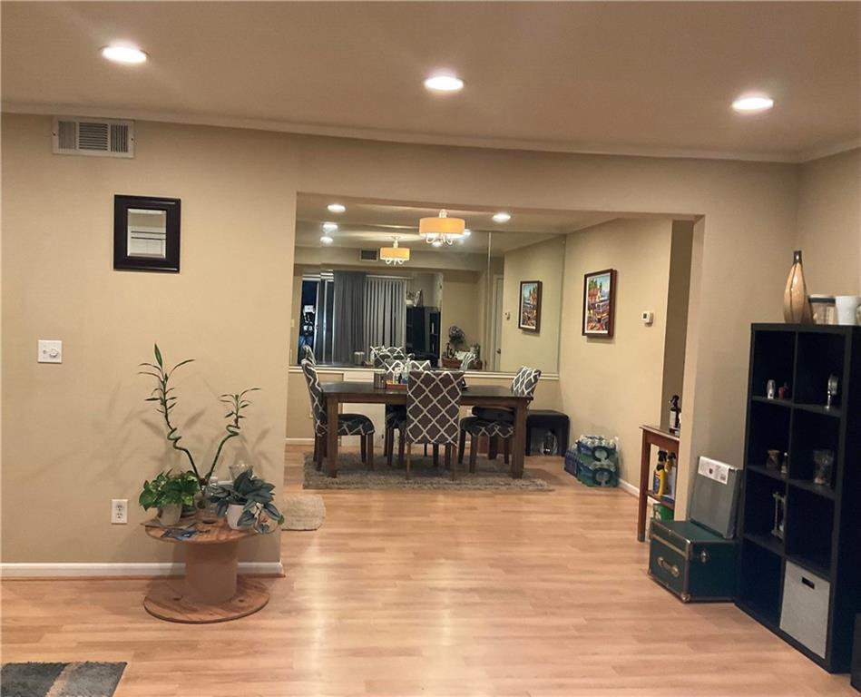 6851 Roswell Road, Unit O24 Sandy Springs, GA 30328 - Photo 3 of 10 a living room with furniture potted plant and kitchen view