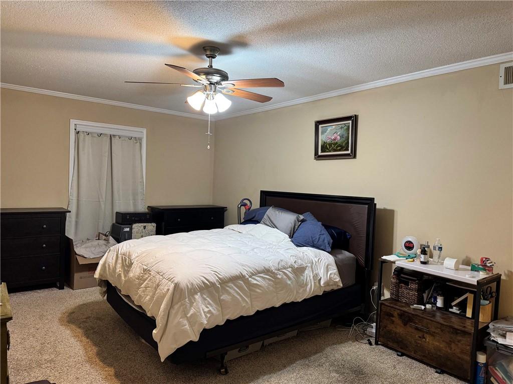 6851 Roswell Road, Unit O24 Sandy Springs, GA 30328 - Photo 7 of 10 a bedroom with a bed and a chandelier