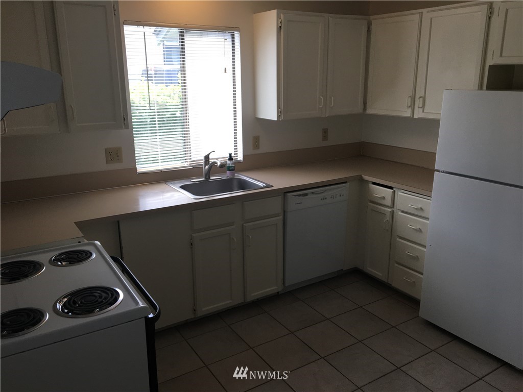 513-515 South Tobin Street Renton, WA 98057 - Photo 8 of 21 a kitchen with a sink appliances and cabinets