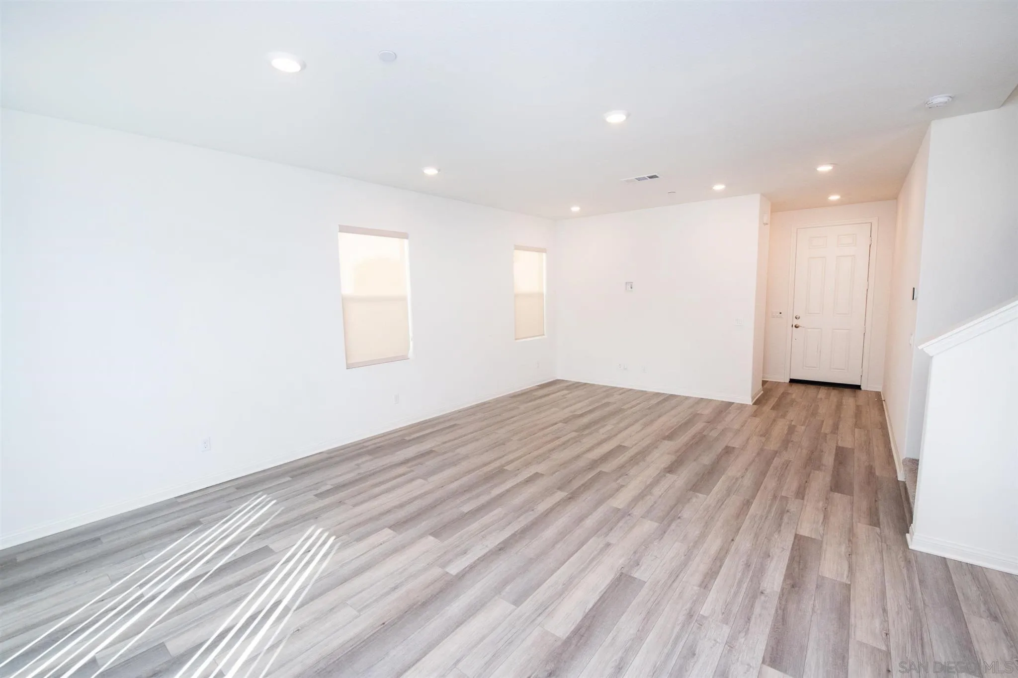 10711 Porter Terrace Spring Valley, CA 91978 - Photo 6 of 17 an empty room with wooden floor and windows
