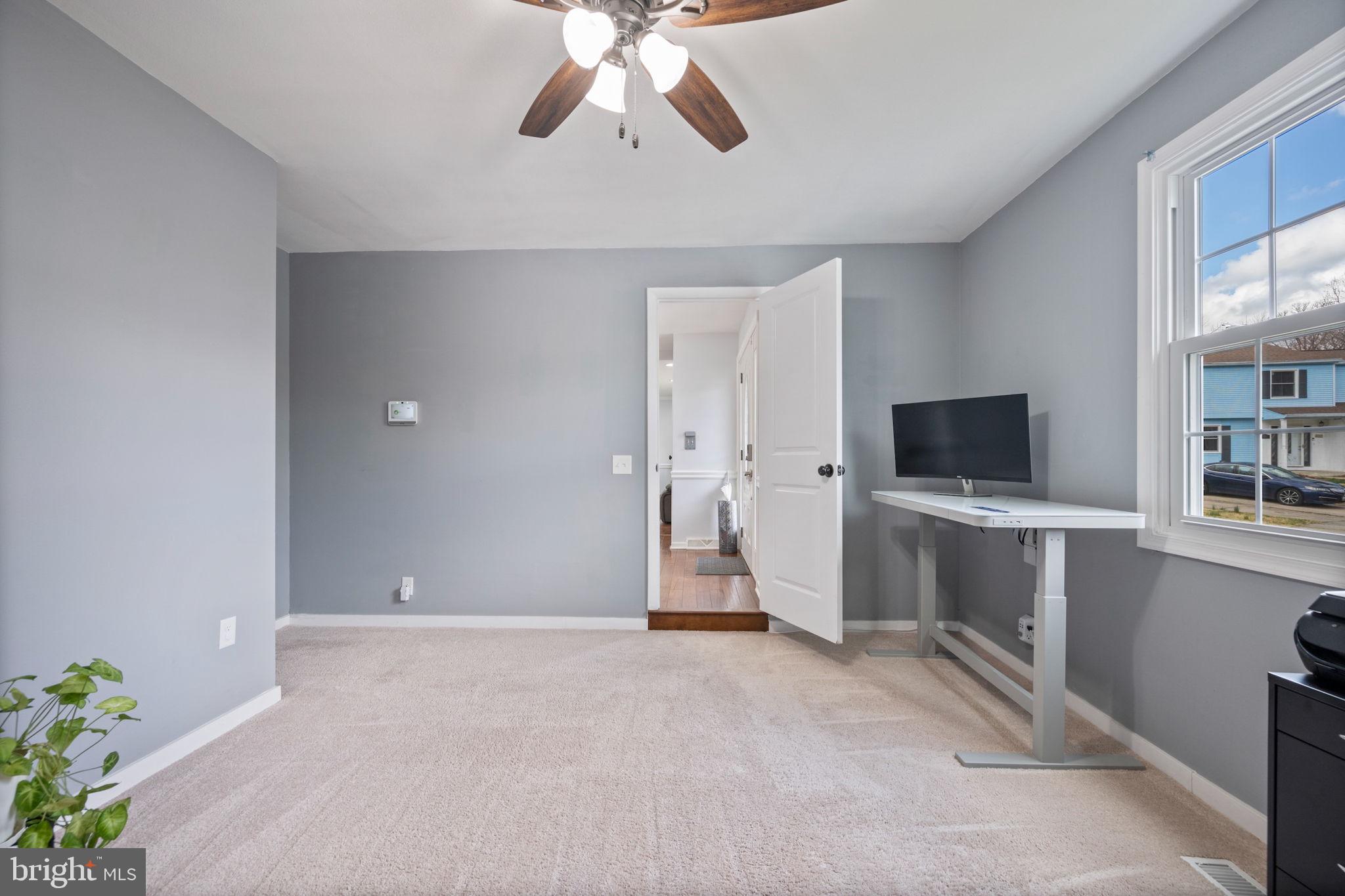 645 Ridgefield Court Glen Burnie, MD 21061 - Photo 14 of 62 a view of an empty room with a window and a flat screen tv