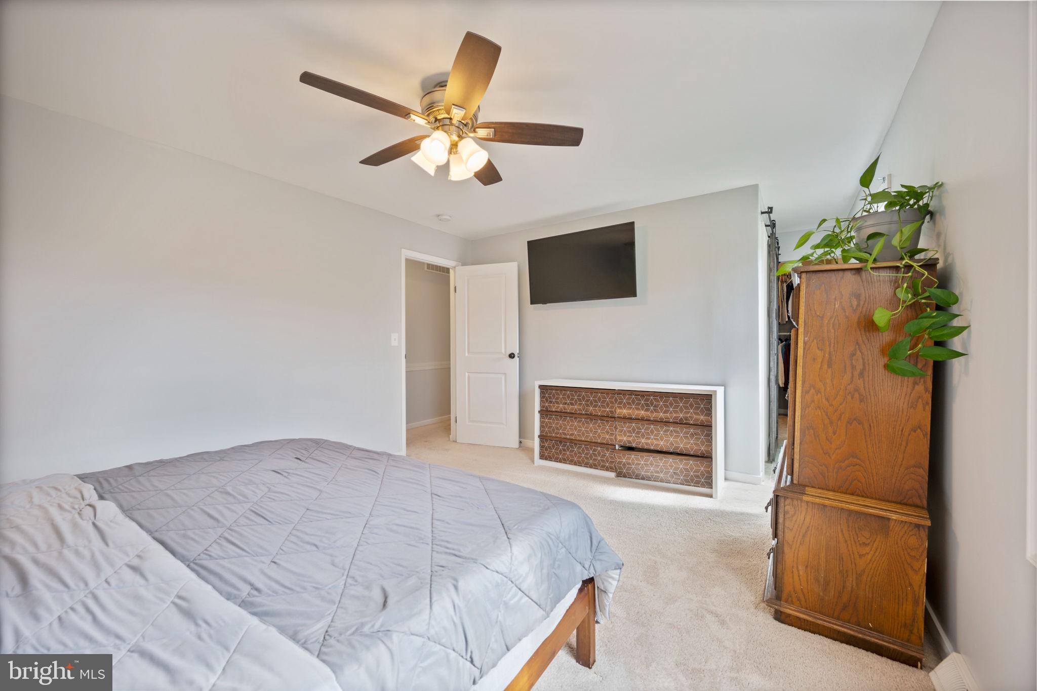 645 Ridgefield Court Glen Burnie, MD 21061 - Photo 19 of 62 a bedroom with a bed and a flat screen tv