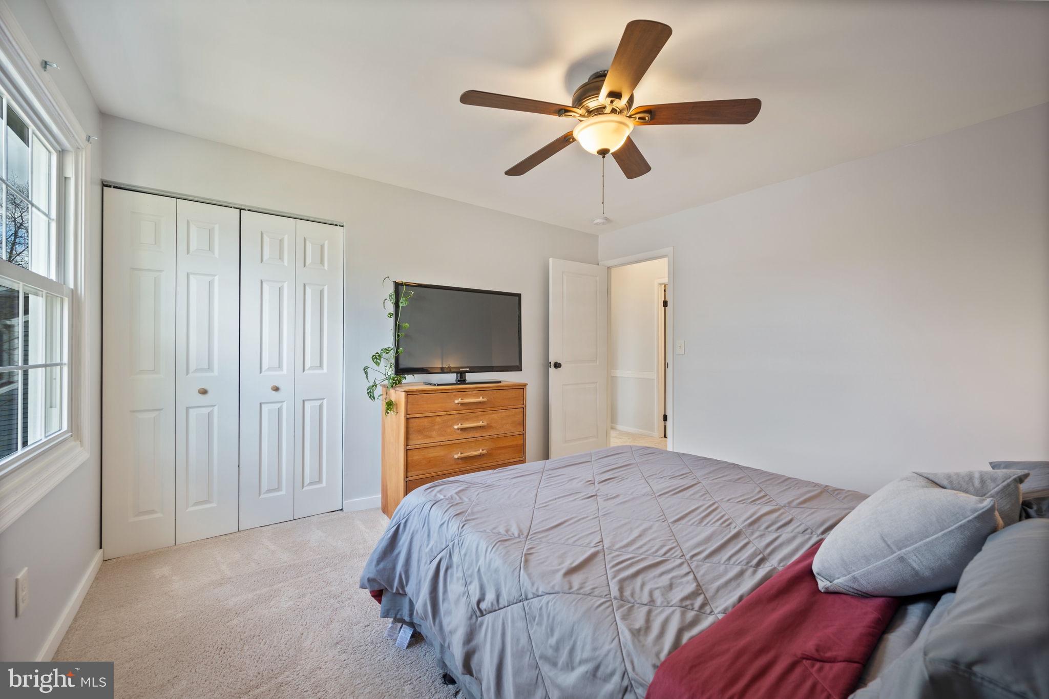 645 Ridgefield Court Glen Burnie, MD 21061 - Photo 24 of 62 a bedroom with a bed and a flat tv screen on dresser