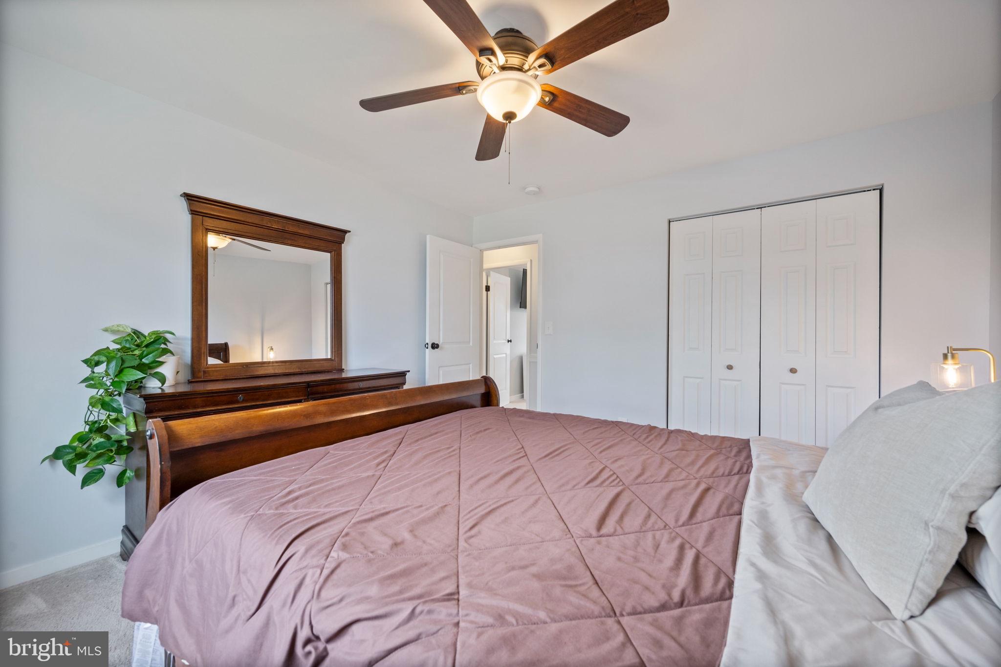 645 Ridgefield Court Glen Burnie, MD 21061 - Photo 26 of 62 a bedroom with a bed and a chandelier
