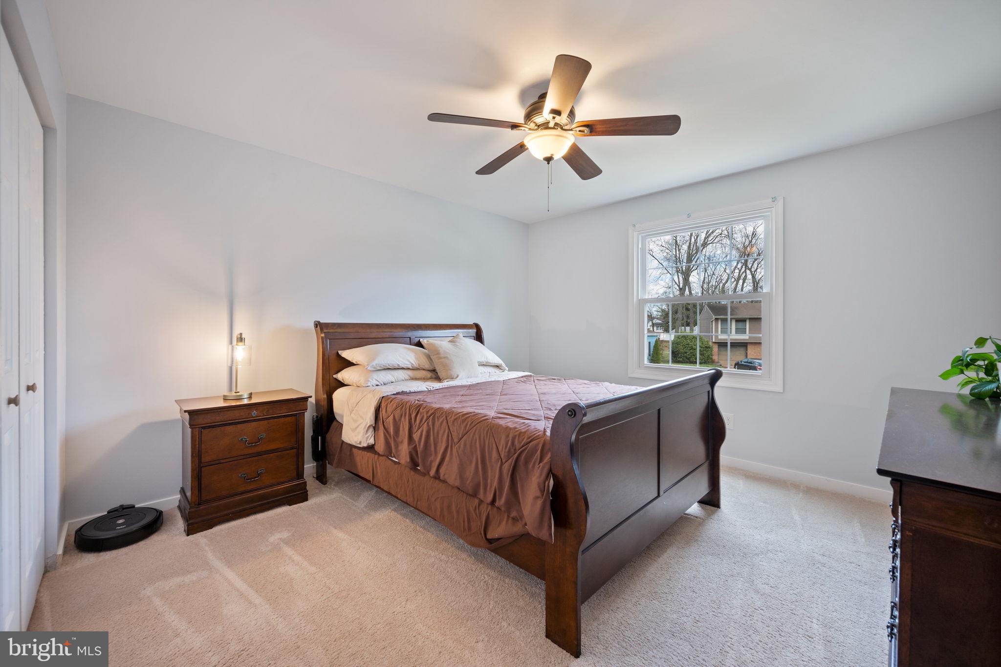 645 Ridgefield Court Glen Burnie, MD 21061 - Photo 27 of 62 a bedroom with a bed and a potted plant