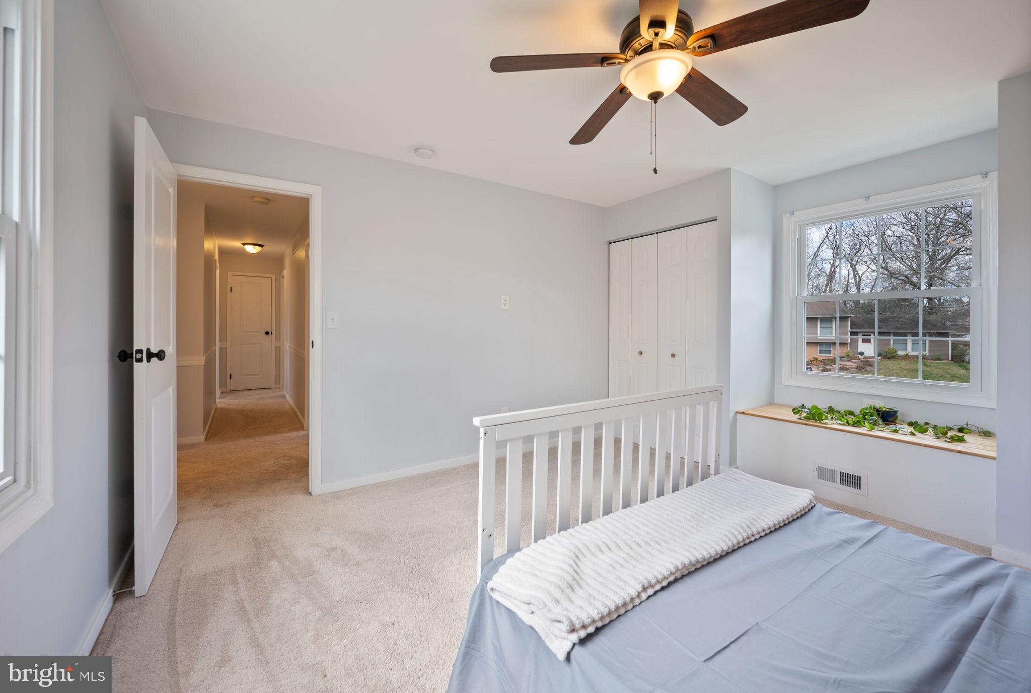 645 Ridgefield Court Glen Burnie, MD 21061 - Photo 30 of 62 a room with a bed and a chandelier fan