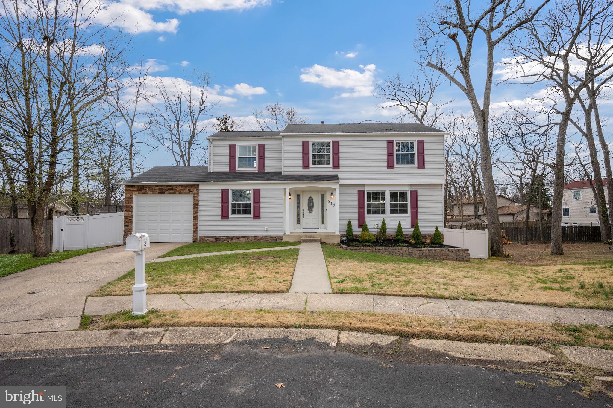 645 Ridgefield Court Glen Burnie, MD 21061 - Photo 36 of 62 a view of a brick house next to a yard with large trees