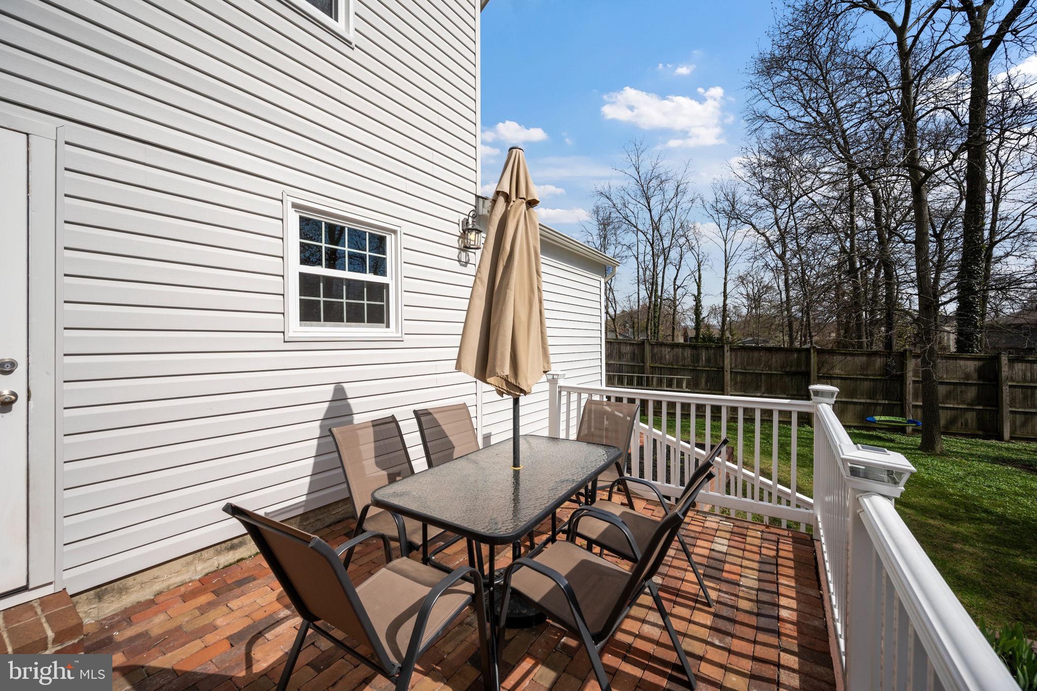645 Ridgefield Court Glen Burnie, MD 21061 - Photo 38 of 62 a view of a patio with a table and chairs