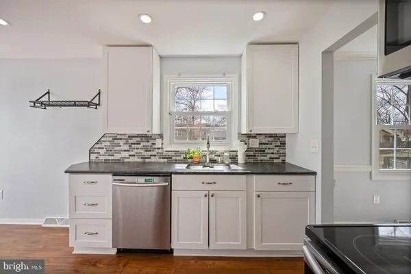 a kitchen with granite countertop a sink and cabinets