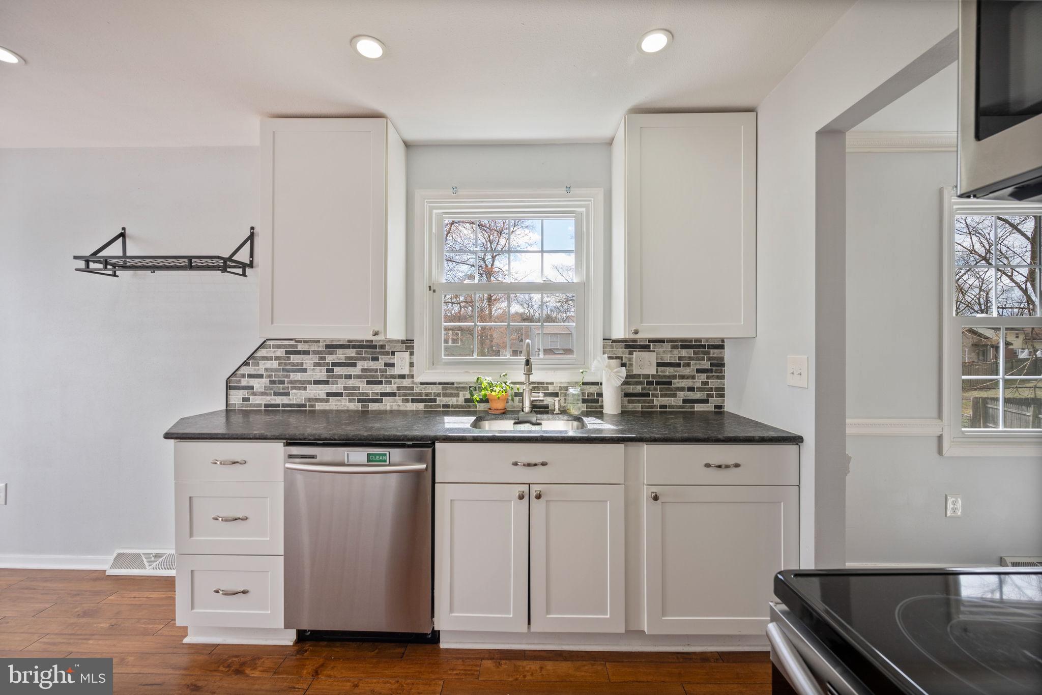 645 Ridgefield Court Glen Burnie, MD 21061 - Photo 4 of 62 a kitchen with granite countertop a sink and cabinets