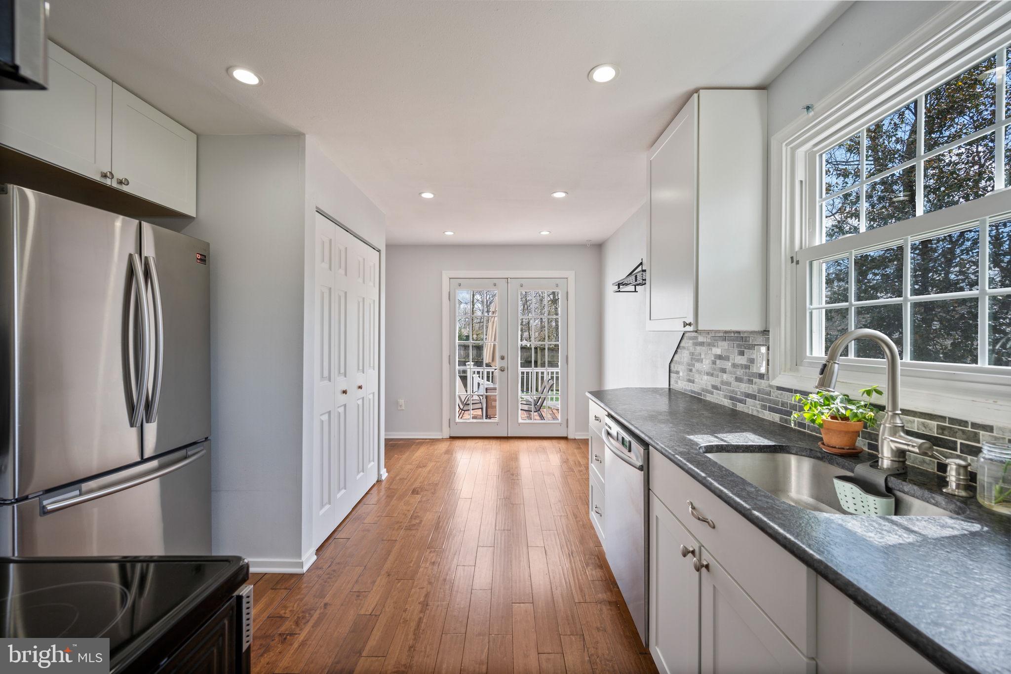 645 Ridgefield Court Glen Burnie, MD 21061 - Photo 5 of 62 a kitchen with stainless steel appliances a refrigerator a sink a stove and cabinets