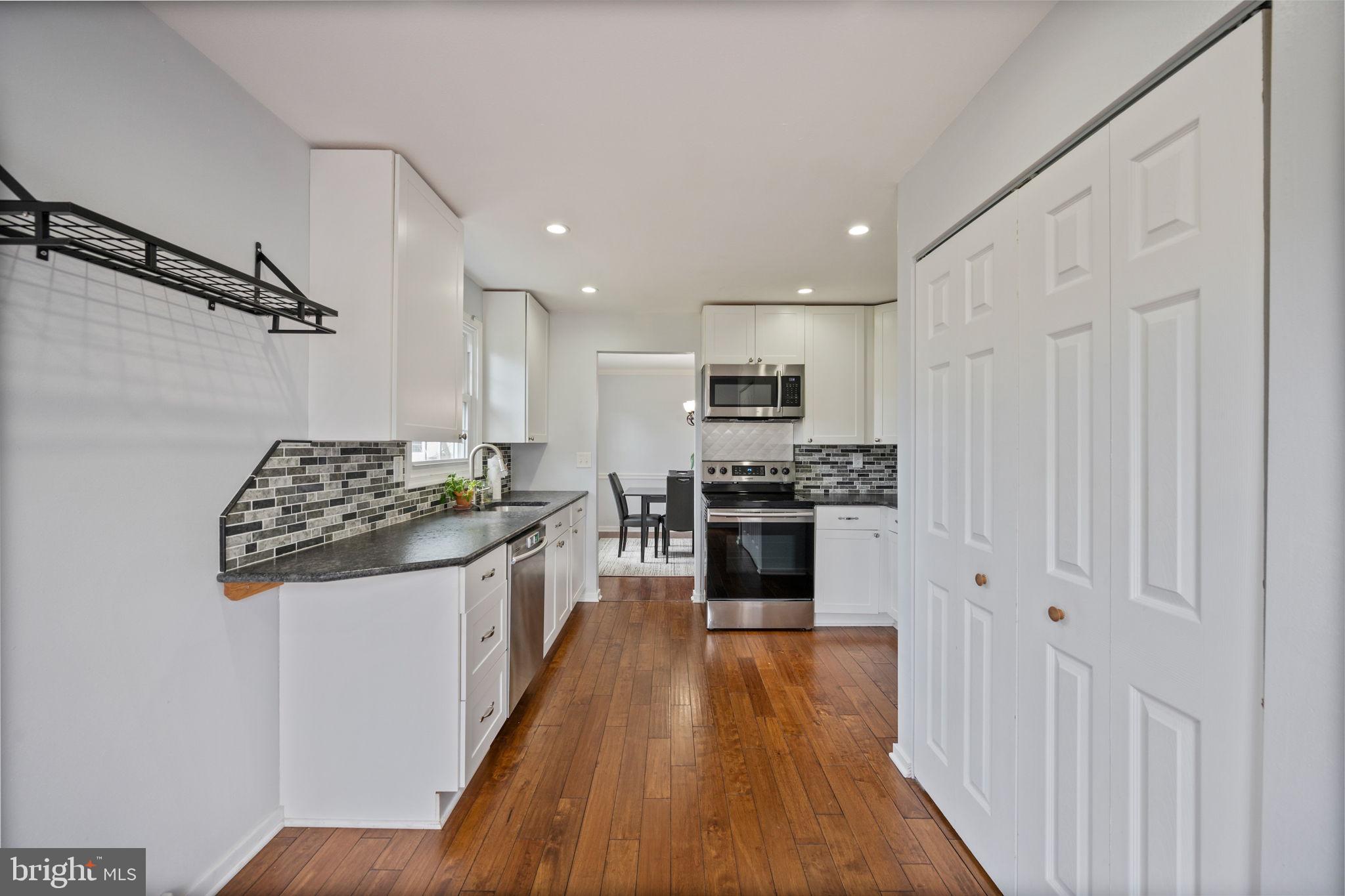 645 Ridgefield Court Glen Burnie, MD 21061 - Photo 6 of 62 a kitchen with stainless steel appliances a refrigerator and a stove top oven