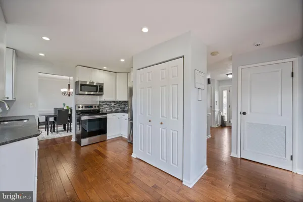 a kitchen with stainless steel appliances a refrigerator and a stove top oven