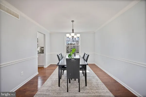a dining room with furniture a rug and wooden floor