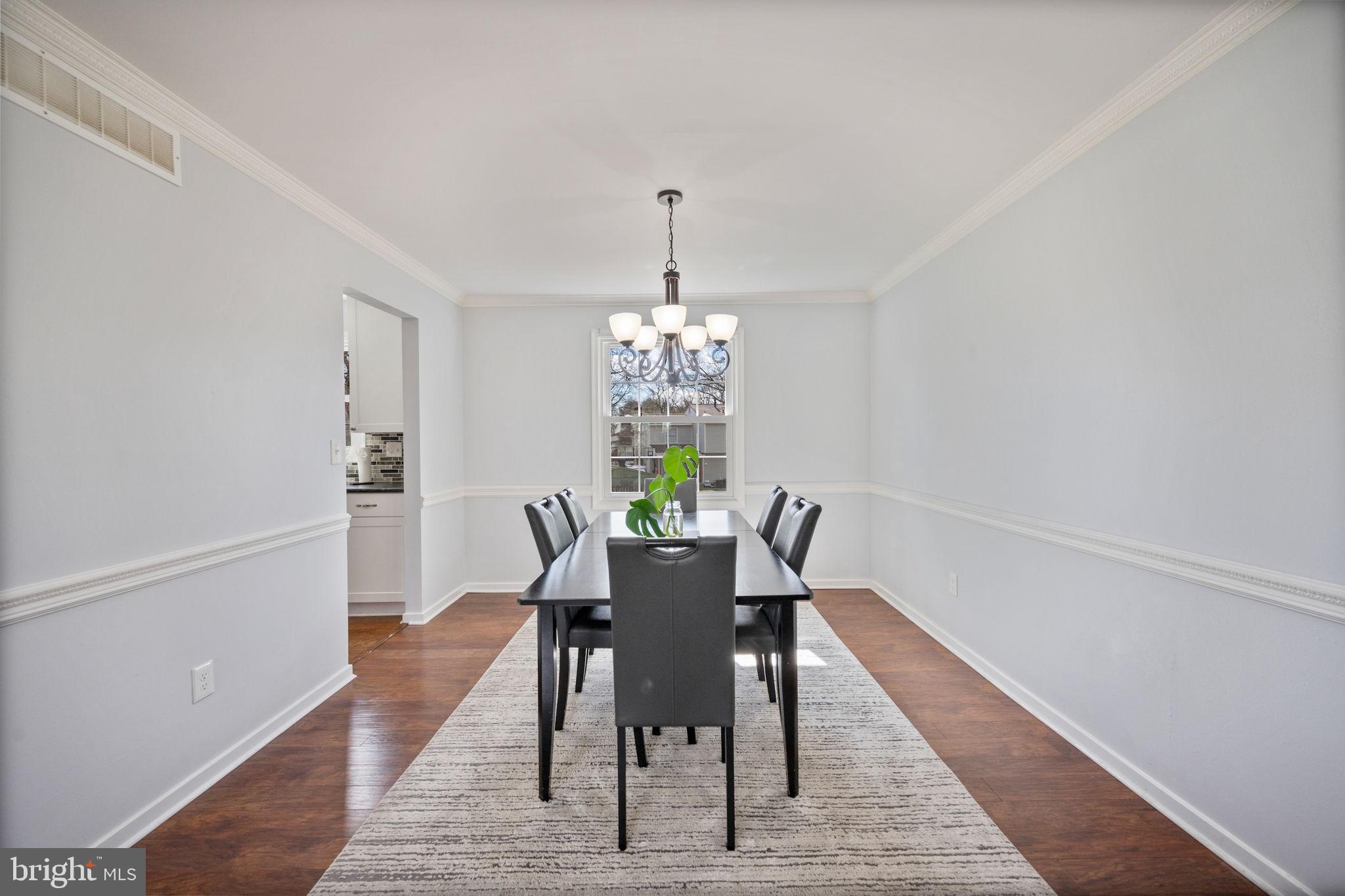645 Ridgefield Court Glen Burnie, MD 21061 - Photo 9 of 62 a dining room with furniture a rug and wooden floor