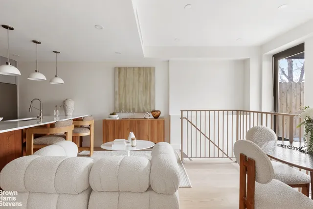 a bedroom with furniture and a large window