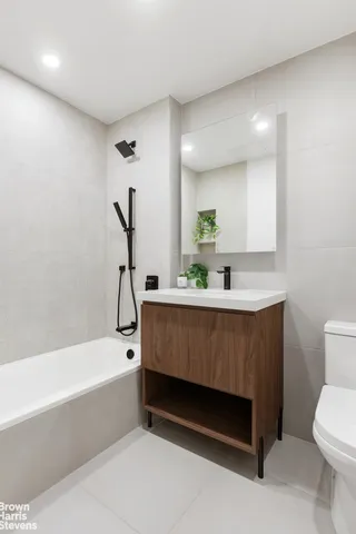 a bathroom with a bathtub a sink and a toilet