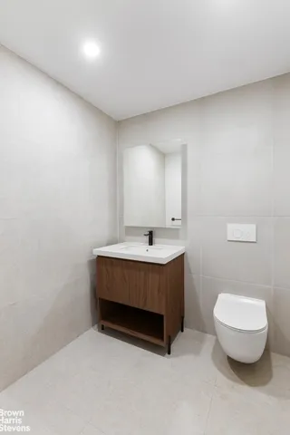 a bathroom with a sink a toilet and mirror