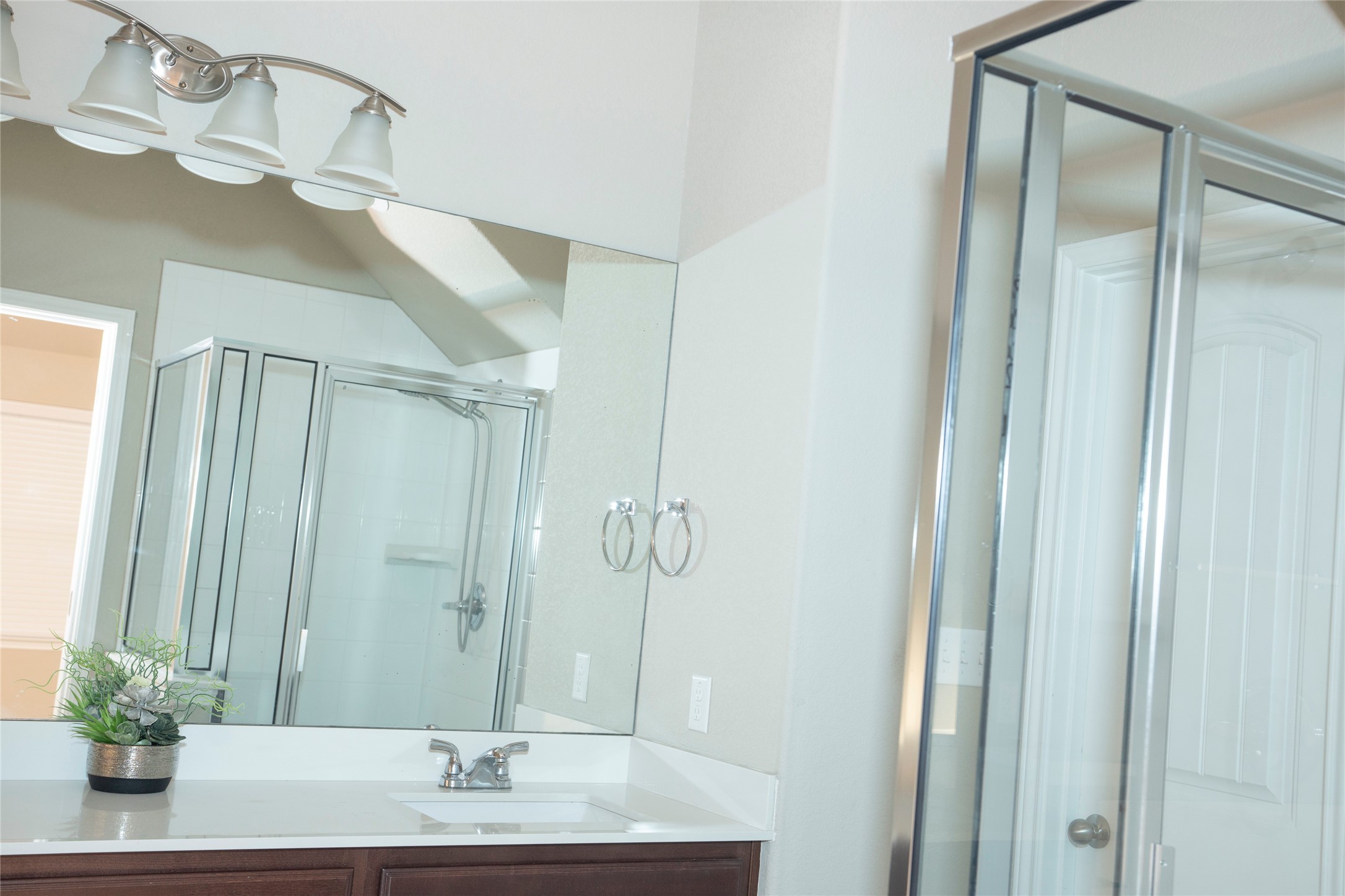 20916 Carries Ranch Road Pflugerville, TX 78660 - Photo 29 of 40 a bathroom with a granite countertop sink a mirror and a shower