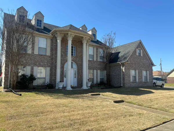 a front view of a house with a yard