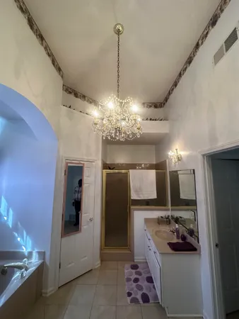 a dining room filled with furniture and a chandelier