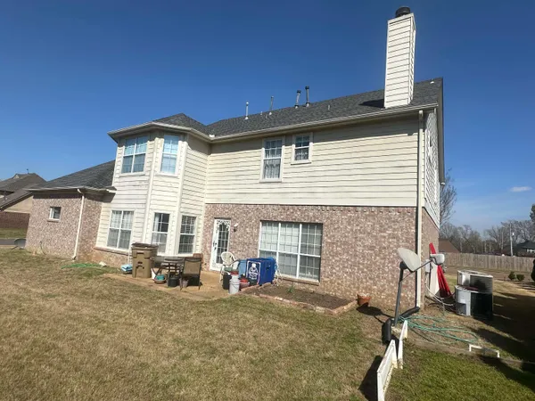 a view of a house with a backyard