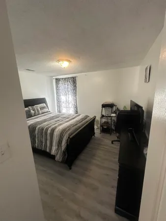 a bedroom with a bed and dresser