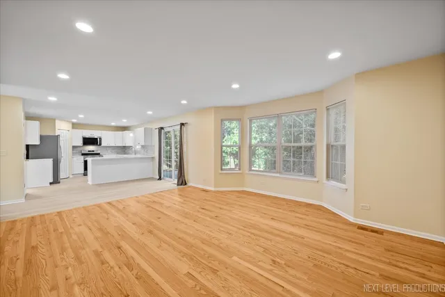 a big room with wooden floor and windows
