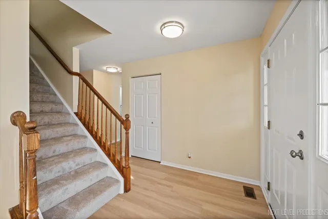 a view of a hallway with wooden floor and entryway