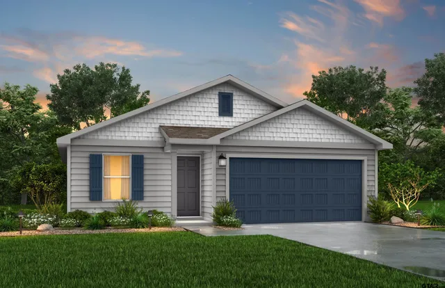 a front view of a house with a garden and plants