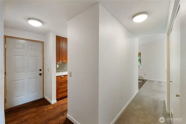 a view of an empty room with wooden floor