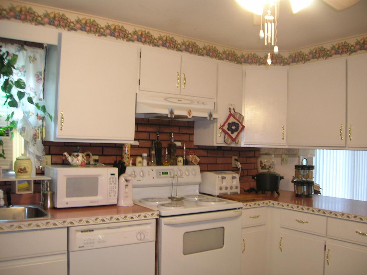 1612 Maple Road Effort, PA 18330 - Photo 3 of 7 a kitchen with appliances cabinets and a table