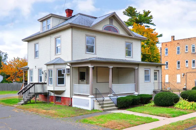 a view of a house with a yard and plants