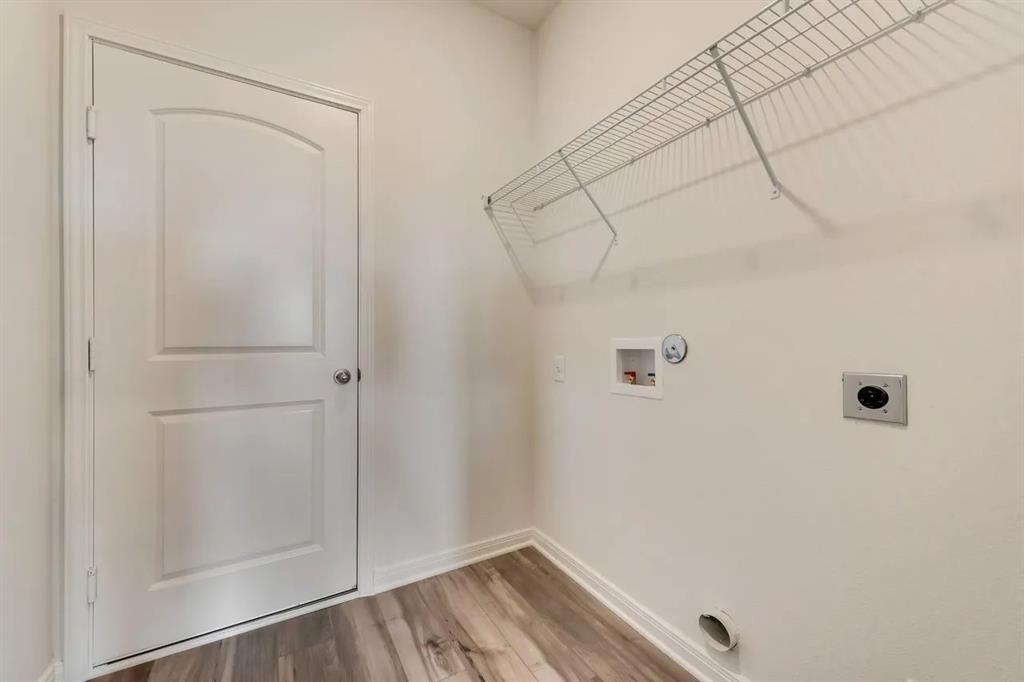 912 Mallorie Lane Ferris, TX 75125 - Photo 13 of 24 Laundry area with electric dryer hookup, light wood-style floors, hookup for a washing machine, and gas dryer hookup