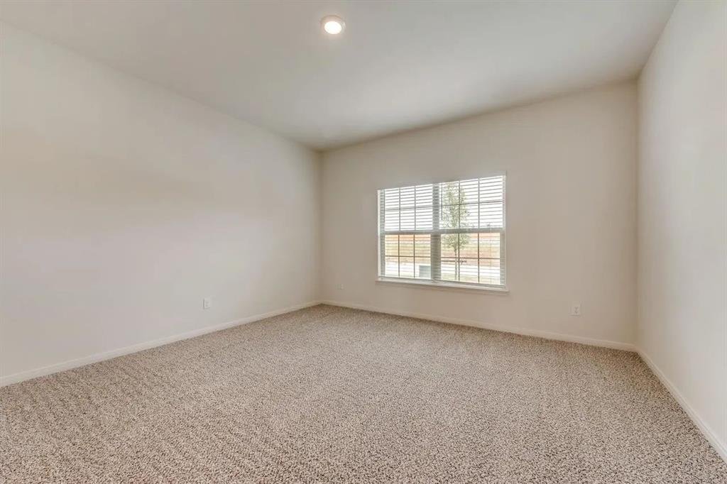 912 Mallorie Lane Ferris, TX 75125 - Photo 14 of 24 Carpeted spare room with baseboards and recessed lighting