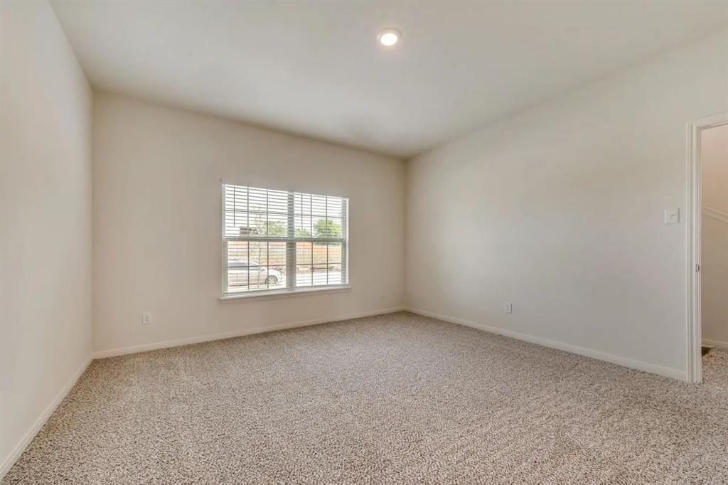 912 Mallorie Lane Ferris, TX 75125 - Photo 16 of 24 Empty room featuring light colored carpet and recessed lighting