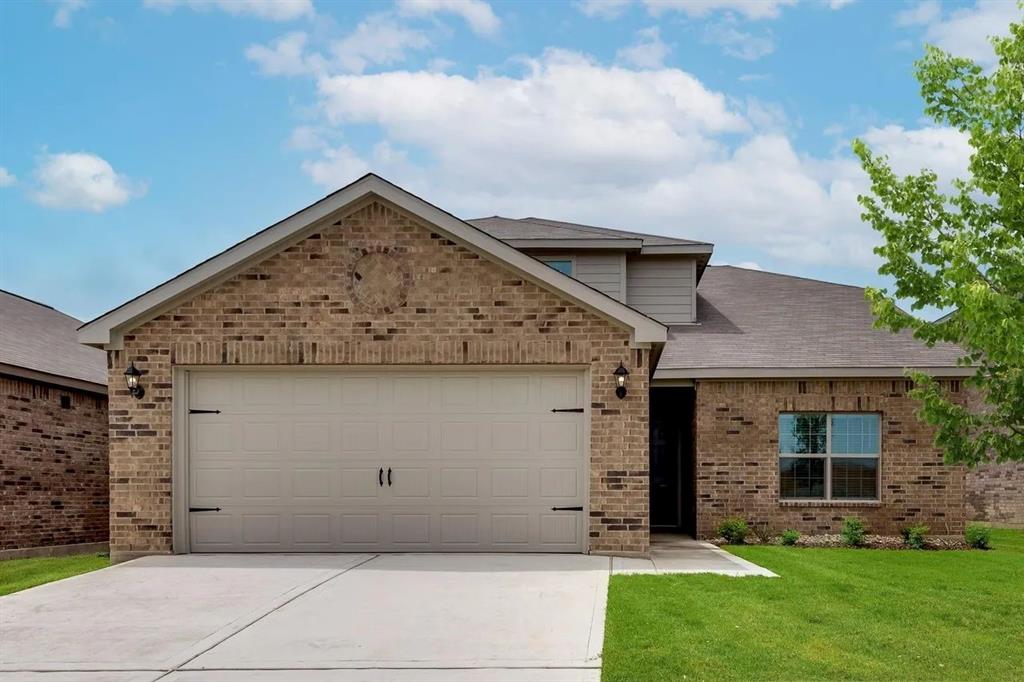 912 Mallorie Lane Ferris, TX 75125 - Photo 2 of 24 View of front of home featuring brick siding, roof with shingles, concrete driveway, a garage, and a front yard