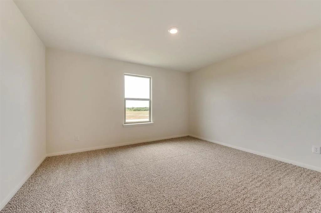 912 Mallorie Lane Ferris, TX 75125 - Photo 21 of 24 Spare room featuring light colored carpet and recessed lighting