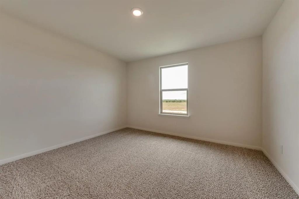 912 Mallorie Lane Ferris, TX 75125 - Photo 23 of 24 Carpeted spare room featuring baseboards and recessed lighting