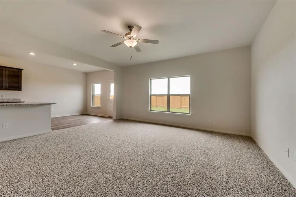 912 Mallorie Lane Ferris, TX 75125 - Photo 5 of 24 Unfurnished living room with light colored carpet, ceiling fan, and recessed lighting