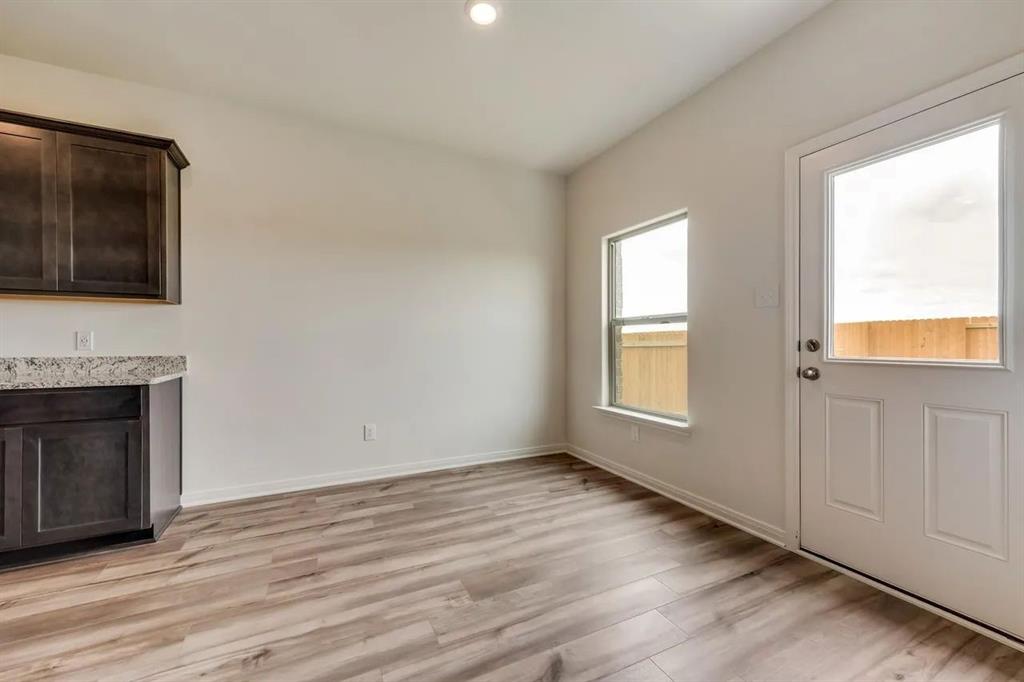 912 Mallorie Lane Ferris, TX 75125 - Photo 8 of 24 Unfurnished living room with light wood-type flooring and recessed lighting