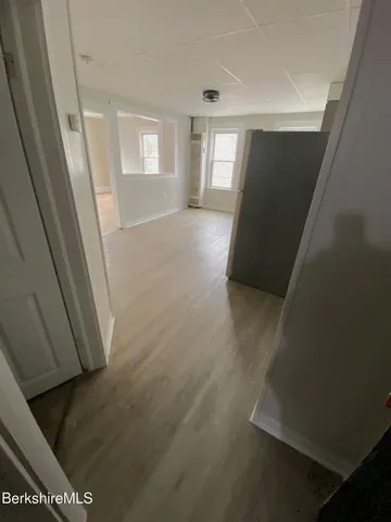 a view of hallway with window and stairs