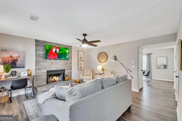 a living room with furniture and a fireplace