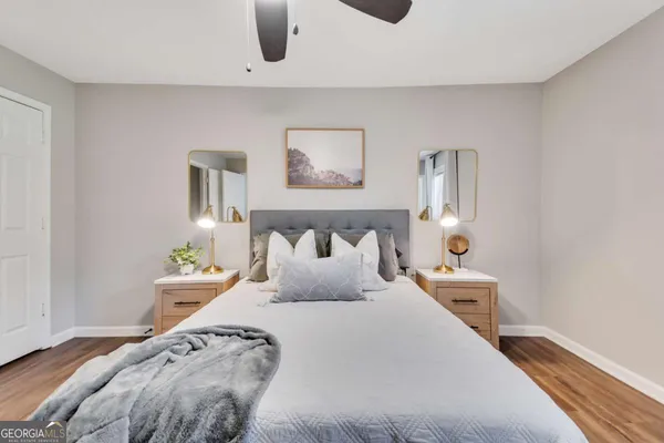 a bedroom with bed and night stand