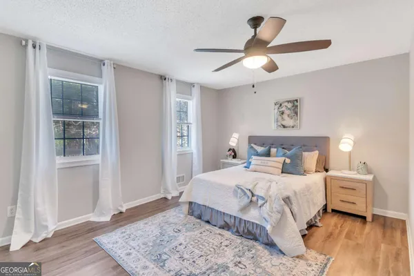 a bedroom with a large bed and a chandelier
