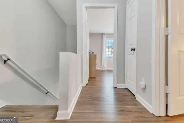 a view of a hallway with wooden floor